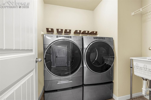 2997 Bright Moon Dr, Colorado Springs, CO 80908 - laundry room featuring washing machine and dryer and baseboards