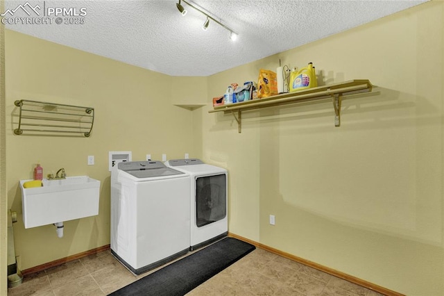35 Lowick Dr, Colorado Springs, CO 80906 - laundry area featuring independent washer and dryer, a textured ceiling, and track lighting