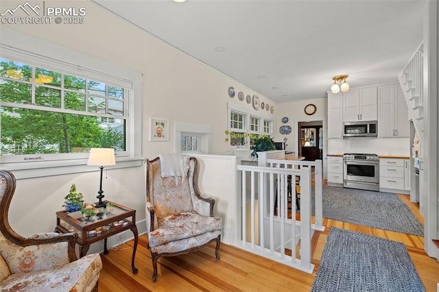 13 2nd St, Colorado Springs, CO 80906 - living area with light wood-style floors and an upstairs landing