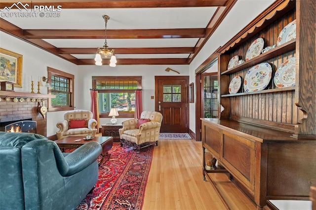 13 2nd St, Colorado Springs, CO 80906 - living room with beamed ceiling, light wood-style floors, and a brick fireplace