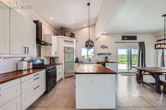 6925 Ht Ranch Trl, Colorado Springs, CO 80908 - kitchen with wood counters, black range with gas stovetop, wall chimney range hood, concrete flooring, and recessed lighting