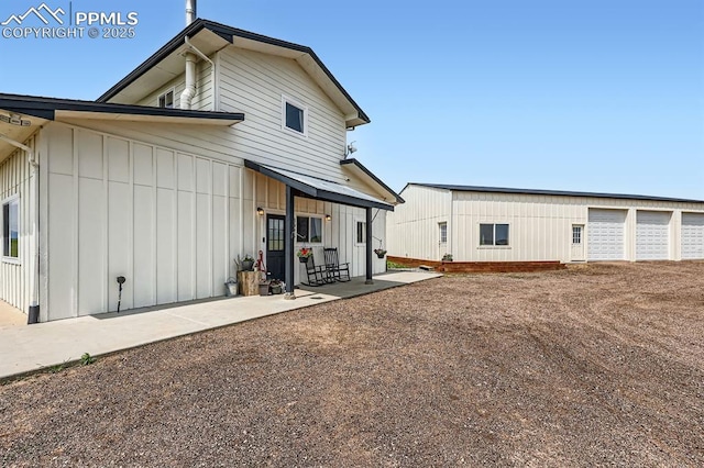 6925 Ht Ranch Trl, Colorado Springs, CO 80908 - rear view of house featuring board and batten siding and a patio