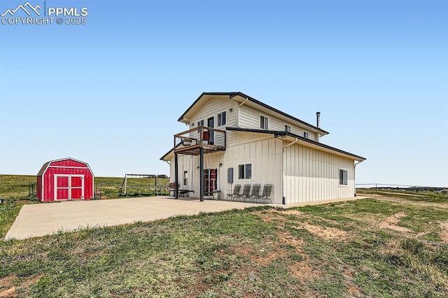 6925 Ht Ranch Trl, Colorado Springs, CO 80908 - back of property with a balcony, a storage unit, a patio area, and a lawn