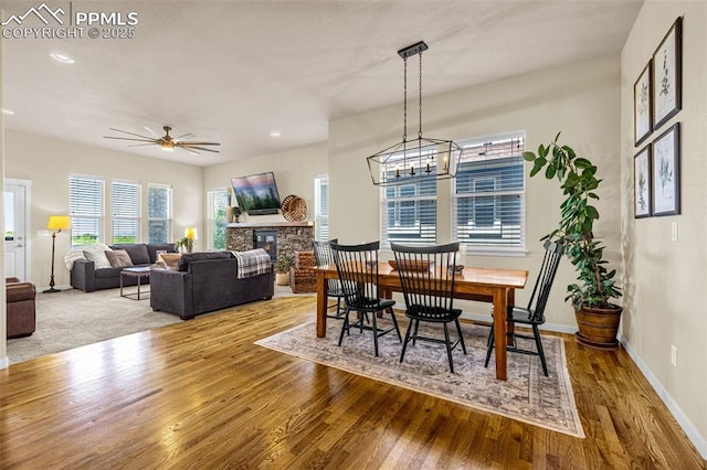 4187 Notch Trl, Colorado Springs, CO 80924 - dining space with wood finished floors, a ceiling fan, healthy amount of natural light, recessed lighting, and a fireplace