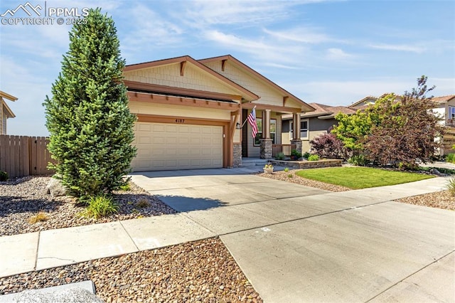 4187 Notch Trl, Colorado Springs, CO 80924 - craftsman-style house with driveway, an attached garage, and a porch
