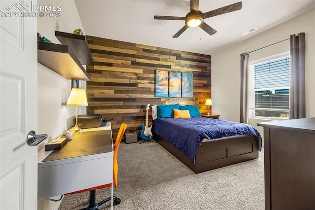 4187 Notch Trl, Colorado Springs, CO 80924 - bedroom with wooden walls, carpet flooring, and a ceiling fan