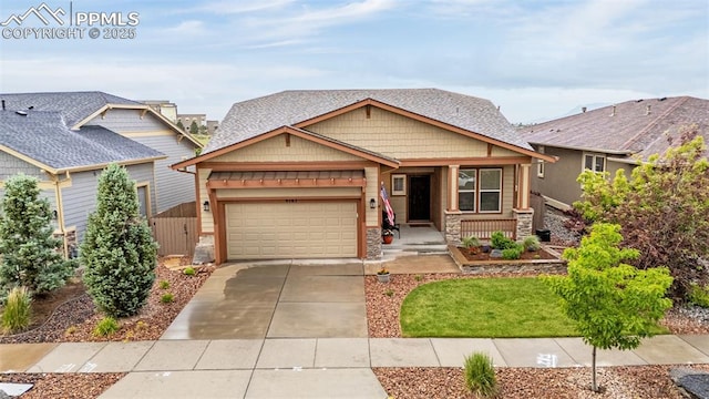 4187 Notch Trl, Colorado Springs, CO 80924 - craftsman house with stone siding, covered porch, driveway, a garage, and a front lawn