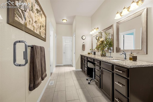 4187 Notch Trl, Colorado Springs, CO 80924 - bathroom featuring double vanity and baseboards