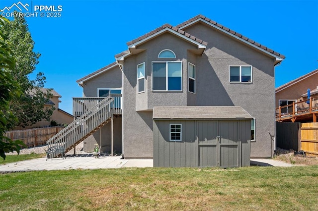 7544 Lake Ave, Fountain, CO 80817 - back of property featuring a patio, stairway, stucco siding, a shed, and a wooden deck