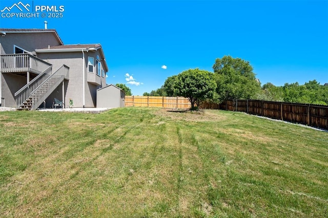 7544 Lake Ave, Fountain, CO 80817 - fenced backyard featuring stairway and a deck