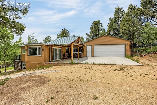 269 Evergreen Rd, Woodland Park, CO 80863 - view of front of house with a detached garage, an outdoor structure, and french doors