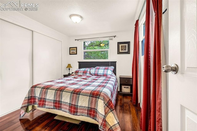 269 Evergreen Rd, Woodland Park, CO 80863 - bedroom featuring wood finished floors, a closet, and a textured ceiling