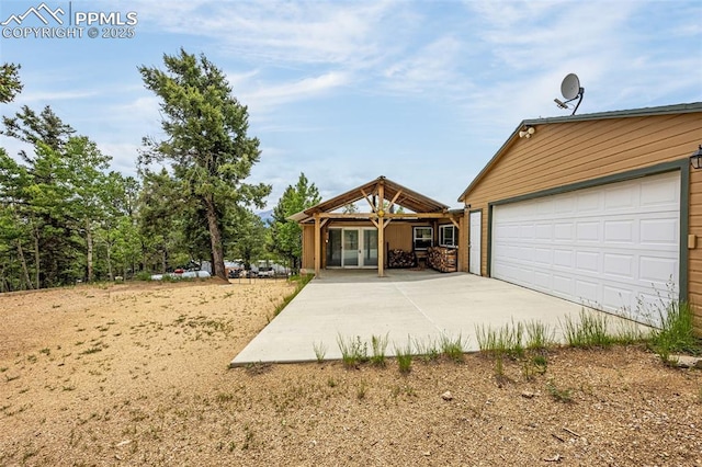 269 Evergreen Rd, Woodland Park, CO 80863 - view of front of house featuring concrete driveway, a garage, and french doors