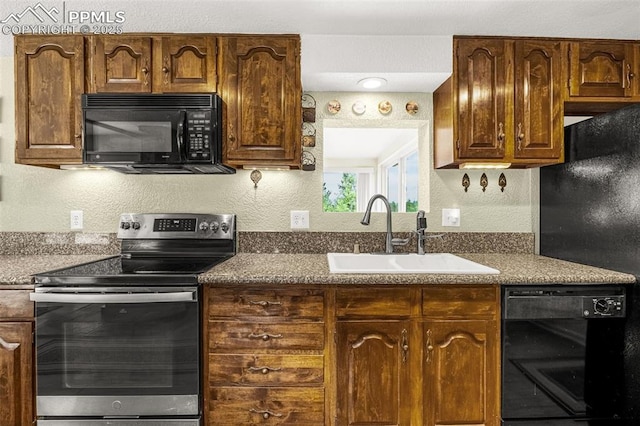 269 Evergreen Rd, Woodland Park, CO 80863 - kitchen with black appliances, dark countertops, and a textured wall