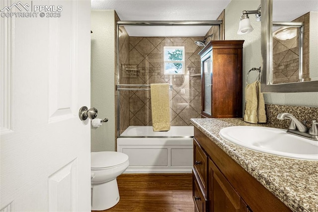 269 Evergreen Rd, Woodland Park, CO 80863 - bathroom with vanity, wood finished floors, and bath / shower combo with glass door