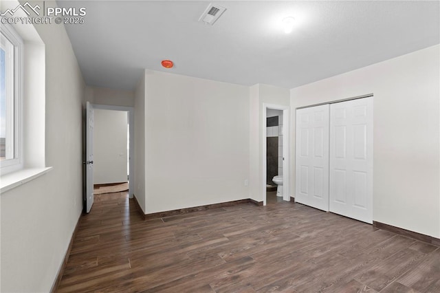 2027 E 14th St, Pueblo, CO 81001 - unfurnished bedroom featuring dark wood-style flooring and a closet