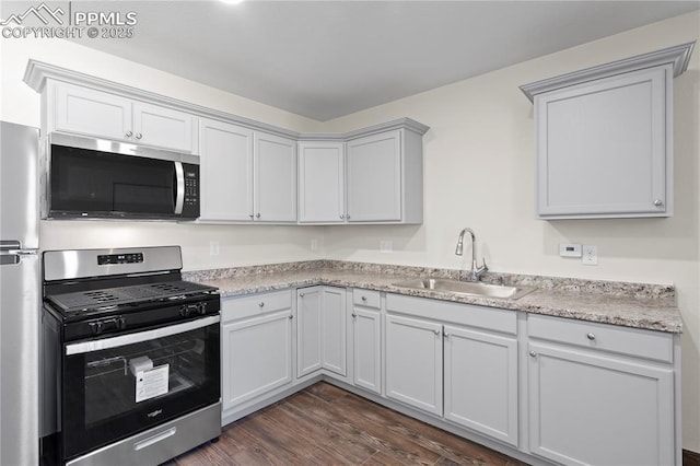 2027 E 14th St, Pueblo, CO 81001 - kitchen featuring appliances with stainless steel finishes and dark wood finished floors