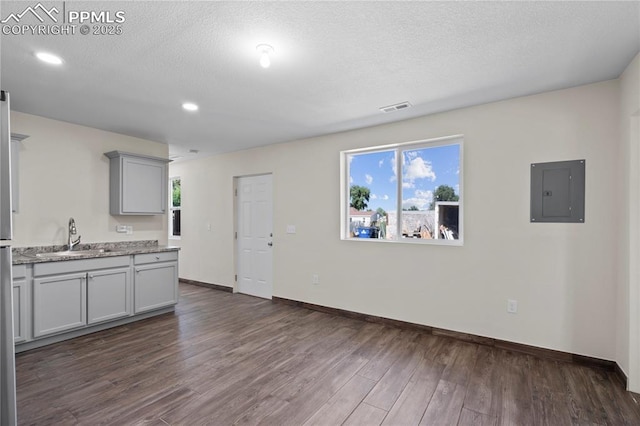 2027 E 14th St, Pueblo, CO 81001 - kitchen with electric panel, gray cabinetry, dark wood-style floors, a textured ceiling, and recessed lighting