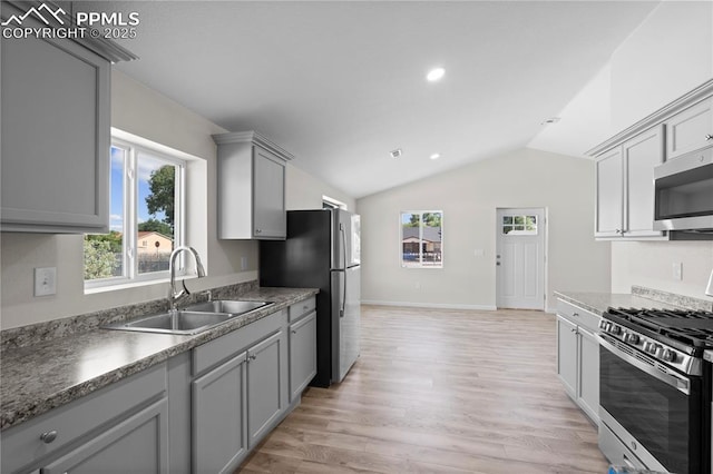 2027 E 14th St, Pueblo, CO 81001 - kitchen featuring stainless steel appliances, gray cabinets, vaulted ceiling, light wood finished floors, and recessed lighting