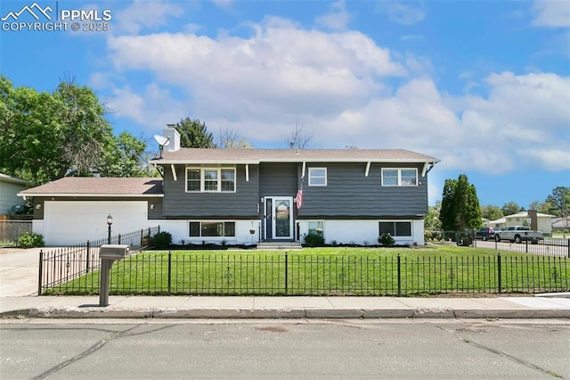 4603 Bella Dr, Colorado Springs, CO 80918 - bi-level home featuring a fenced front yard, a garage, and driveway