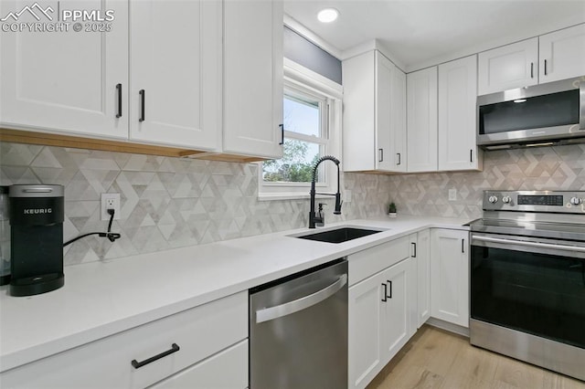 4603 Bella Dr, Colorado Springs, CO 80918 - kitchen with appliances with stainless steel finishes, white cabinets, light countertops, and recessed lighting