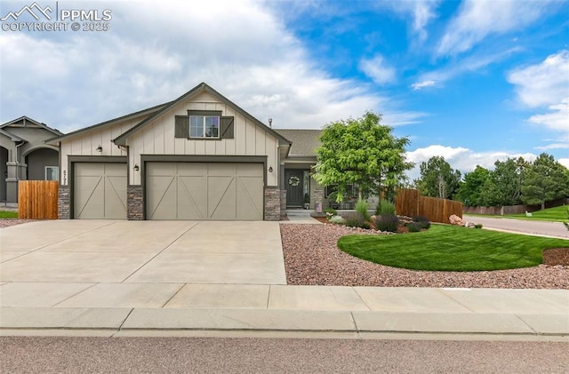 6792 David Anthony Ct, Colorado Springs, CO 80922 - craftsman-style house with driveway, stone siding, a garage, and board and batten siding