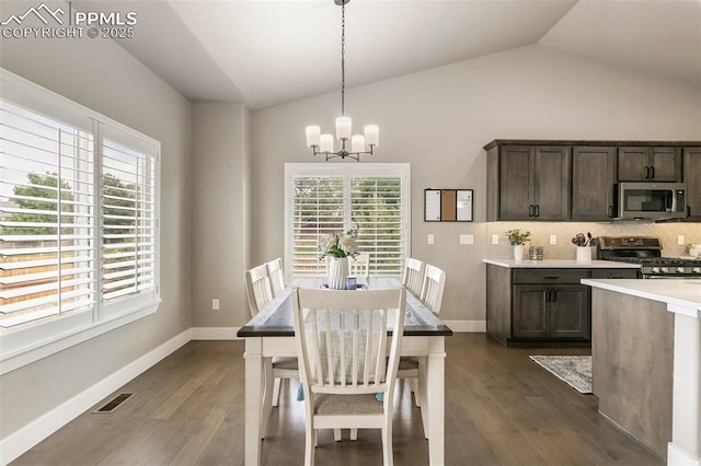 6792 David Anthony Ct, Colorado Springs, CO 80922 - dining space featuring vaulted ceiling, a chandelier, and dark wood-style floors
