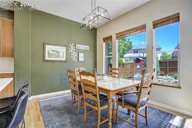 5763 Show Down Ln, Colorado Springs, CO 80923 - dining room featuring wood finished floors and a chandelier