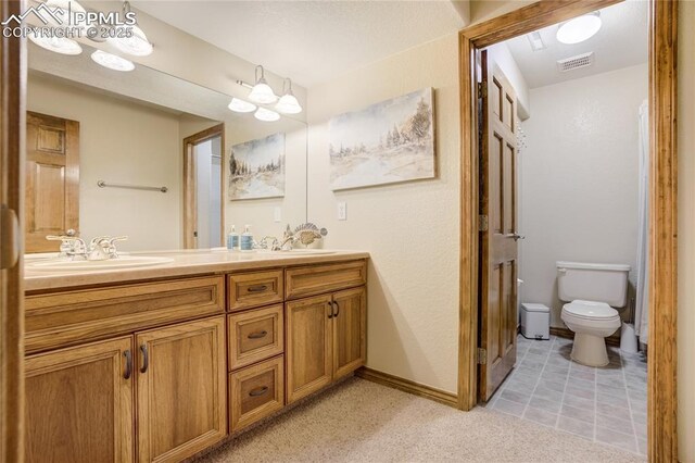 5763 Show Down Ln, Colorado Springs, CO 80923 - bathroom with double vanity and toilet
