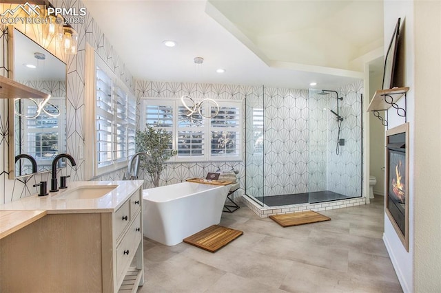17870 New London Rd, Monument, CO 80132 - bathroom with vanity, a freestanding tub, a shower stall, and recessed lighting