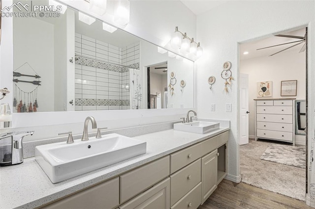 17870 New London Rd, Monument, CO 80132 - bathroom featuring double vanity, wood finished floors, and a tile shower