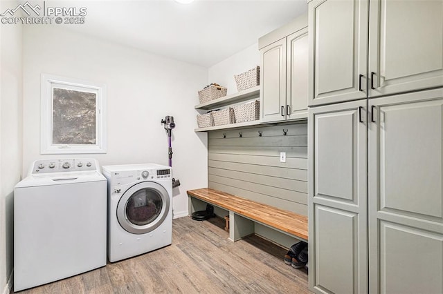 17870 New London Rd, Monument, CO 80132 - washroom featuring independent washer and dryer, light wood-style flooring, and cabinet space