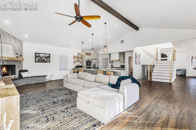 17870 New London Rd, Monument, CO 80132 - living area featuring dark wood-style flooring, a large fireplace, a ceiling fan, stairs, and recessed lighting