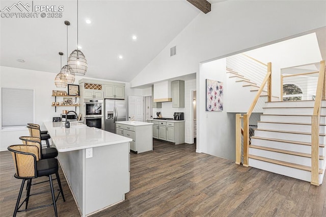 17870 New London Rd, Monument, CO 80132 - kitchen with stainless steel appliances, dark wood-style flooring, a kitchen island, gray cabinets, and beamed ceiling