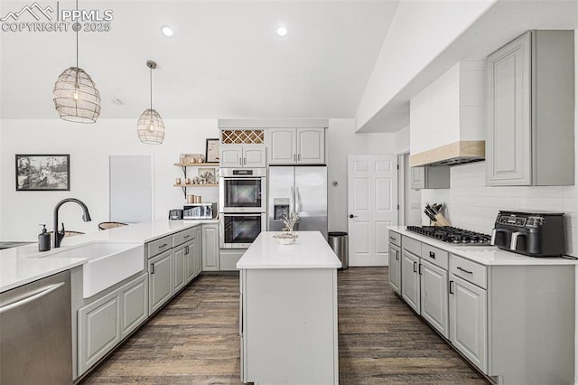 17870 New London Rd, Monument, CO 80132 - kitchen with stainless steel appliances, gray cabinetry, dark wood-type flooring, tasteful backsplash, and a center island