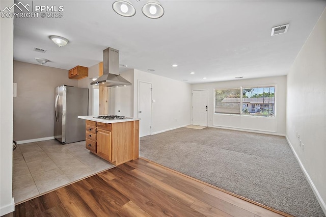 4703 N Weber St, Colorado Springs, CO 80907 - kitchen with island range hood, freestanding refrigerator, light countertops, light wood-style floors, and gas cooktop