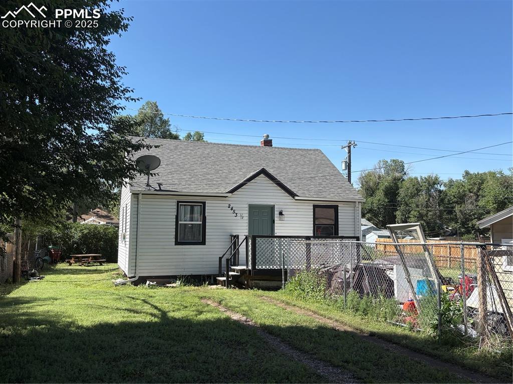 2453 E Willamette Ave Unit 1/2, Colorado Springs, CO 80909 - view of front of home with roof with shingles and a chimney