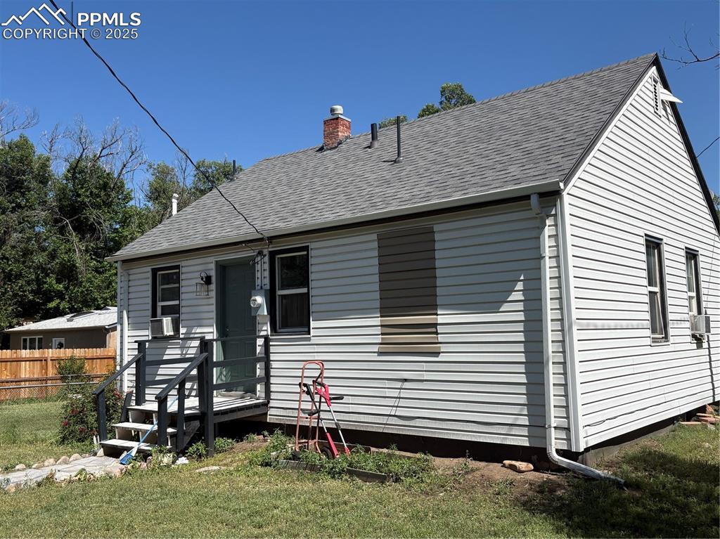 2453 E Willamette Ave Unit 1/2, Colorado Springs, CO 80909 - view of front of home with a chimney, a shingled roof, and cooling unit