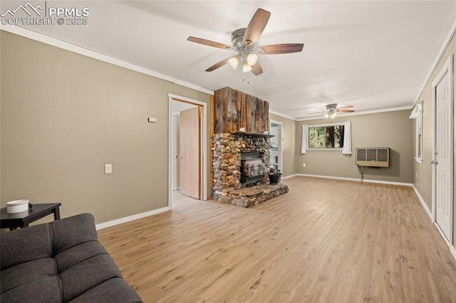 2925 M Path, Cotopaxi, CO 81223 - living room with a wood stove, ceiling fan, light wood-type flooring, and crown molding
