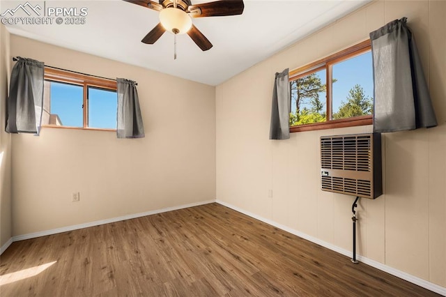 2925 M Path, Cotopaxi, CO 81223 - empty room featuring wood finished floors, ceiling fan, and a wall mounted air conditioner
