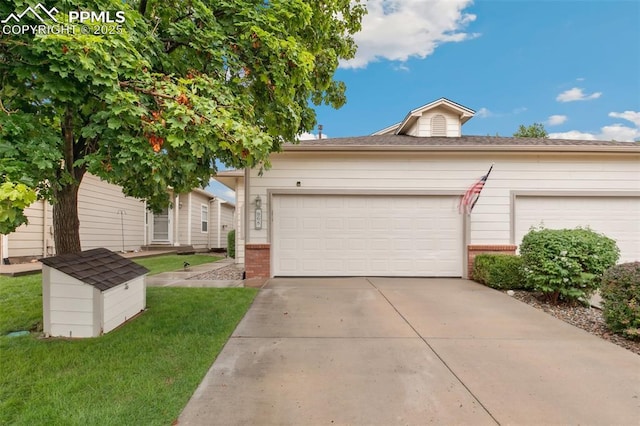 968 Samuel Pt, Colorado Springs, CO 80906 - view of front of house featuring brick siding, driveway, a front yard, and an attached garage