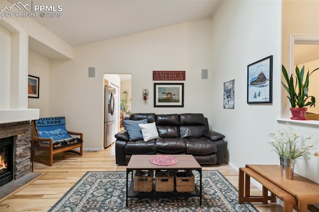 968 Samuel Pt, Colorado Springs, CO 80906 - living area with a fireplace, light wood-style floors, and high vaulted ceiling