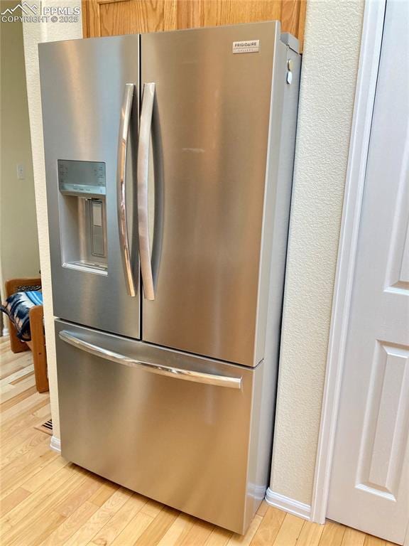 968 Samuel Pt, Colorado Springs, CO 80906 - kitchen view of stainless steel fridge and light wood finished floors
