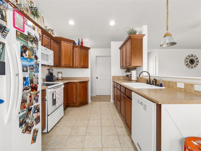 1205 N Picketwire Ln, Pueblo West, CO 81007 - kitchen featuring white appliances, light countertops, a peninsula, brown cabinets, and pendant lighting