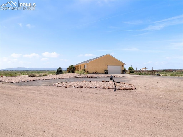 1205 N Picketwire Ln, Pueblo West, CO 81007 - view of yard with an attached garage and driveway