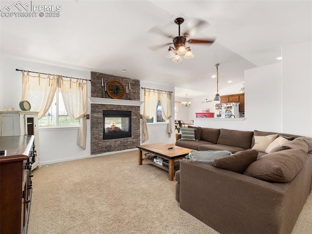 1205 N Picketwire Ln, Pueblo West, CO 81007 - living room featuring ceiling fan, light colored carpet, a fireplace, a chandelier, and recessed lighting