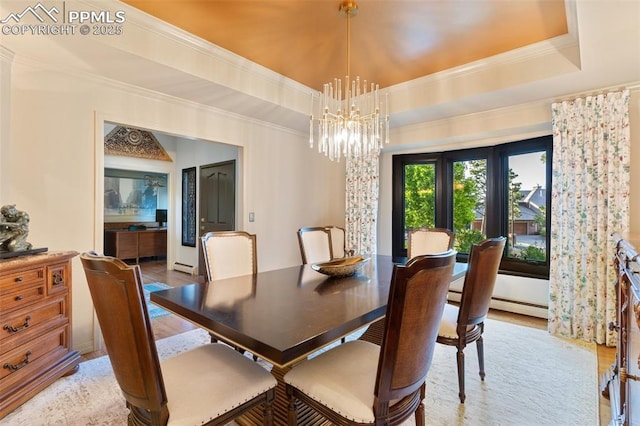 155 Grayson Ct, Colorado Springs, CO 80906 - dining room with a chandelier, light wood-style floors, a tray ceiling, and ornamental molding