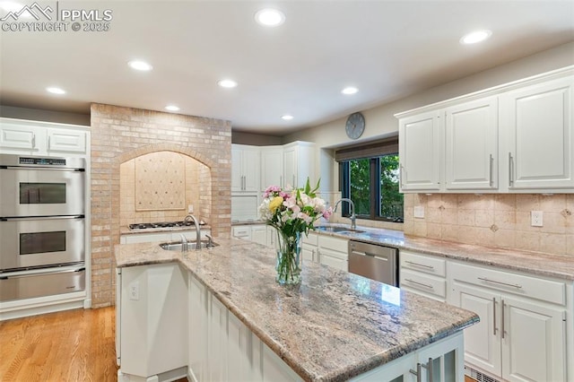 155 Grayson Ct, Colorado Springs, CO 80906 - kitchen with a warming drawer, appliances with stainless steel finishes, recessed lighting, white cabinetry, and decorative backsplash