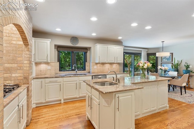 155 Grayson Ct, Colorado Springs, CO 80906 - kitchen featuring stainless steel gas stovetop, light wood-type flooring, recessed lighting, a kitchen island with sink, and tasteful backsplash
