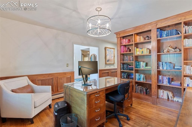 155 Grayson Ct, Colorado Springs, CO 80906 - office featuring a chandelier, a wainscoted wall, a baseboard radiator, and light wood-style floors